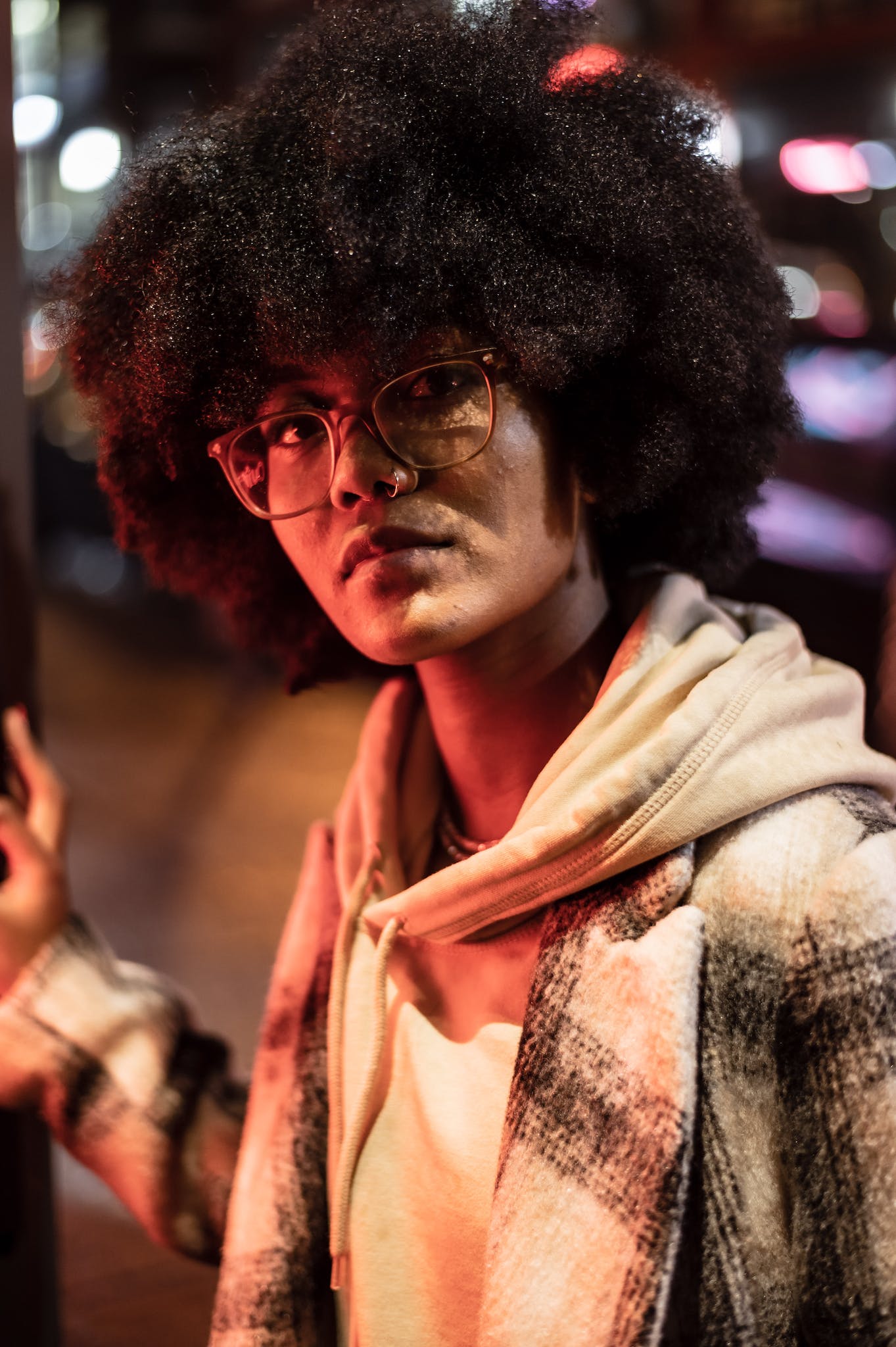 Stylish black woman on dark street